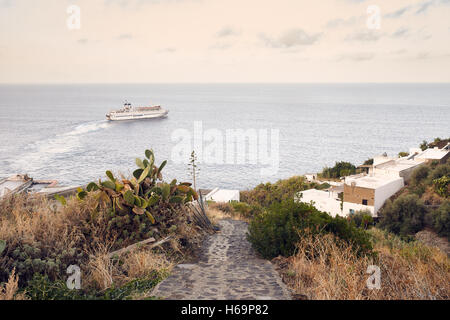 Stromboli, Aeolian islands/Italy – September 19th, 2016. Street in Ginostra with sea view and a ferry boat on background Stock Photo