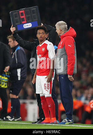 Arsenal manager Arsene Wenger speaks with substitute Chris Willock before he enters the game during the EFL Cup, round of 16 match at the Emirates Stadium, London. Stock Photo