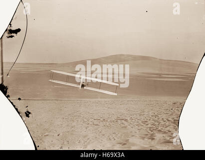 Rear view of Wilbur making a right turn in glide from No. 2 Hill, right wing tipped close to the ground. Stock Photo