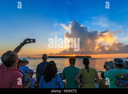 Crazy, joyous sunset celebration scene nightly at Mallory Square in Key West. Visitors gather at sunset to photograph sundown. Stock Photo