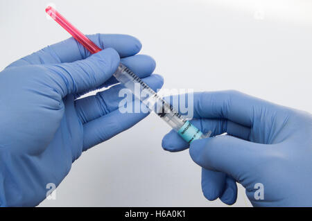 Two Hands Holding a Syringe filled with a Narcotic Pain Medication, Fentanyl Stock Photo