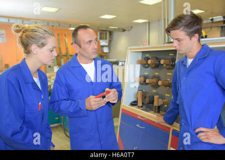 teacher with students in workshop Stock Photo