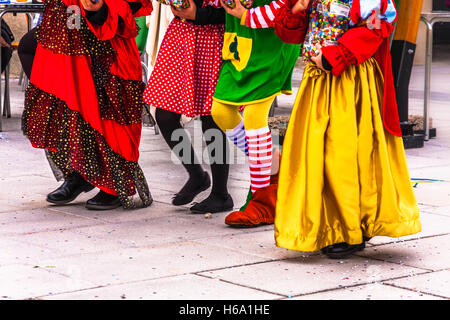 Carnival season: children walking together on the street dressed in colorful carnival costumes Stock Photo