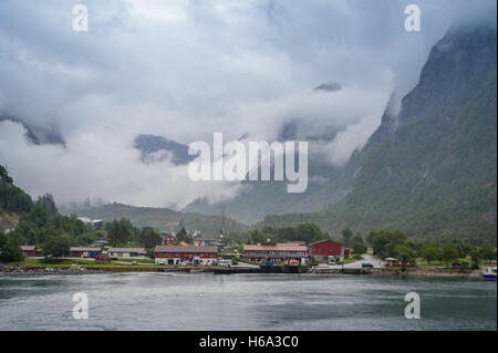 Norwedian village under the mountains in cluds and fog. Stock Photo