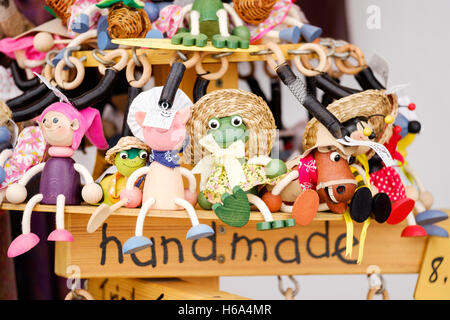 A display of handcrafted wooden toy animals and characters for sale outside a shop Stock Photo