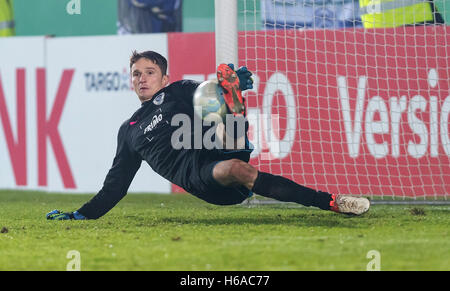 Lotte's goalkeeper Benedikt Fernandez holds the ball in a penalts shot during the German DFB-Cup soccer match between SF Lotte and Bayer Leverkusen at the FRIMO Stadium in Lotte, Germany, 25 October 2016. PHOTO: Guido Kirchner/dpa (EMBARGO CONDITIONS - ATTENTION: The DFB prohibits the utilisation and publication of sequential pictures on the internet and other online media during the match (including half-time). ATTENTION: BLOCKING PERIOD! The DFB permits the further utilisation and publication of the pictures for mobile services (especially MMS) and for DVB-H and DMB only after the end of Stock Photo