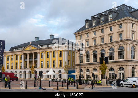 Poundbury, Dorset, UK. 26th Oct, 2016. UK Weather. Queen Mother square in Poundbury in Dorset being readied for the visit of The Queen tomorrow (Thursday 27th) for the unveiling of the statue of the Queen Mother. Also in attendance for the unveiling will be The Duke of Edinburgh, Prince Charles and Camilla. Pictured are the Buckingham Palace replica called Strathmore House and The Duchess of Cornwall Inn. Picture Credit:  Graham Hunt/Alamy Live News Stock Photo