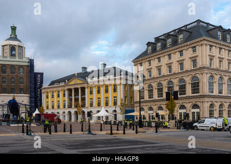 Poundbury, Dorset, UK. 26th Oct, 2016. UK Weather. Queen Mother square in Poundbury in Dorset being readied for the visit of The Queen tomorrow (Thursday 27th) for the unveiling of the statue of the Queen Mother. Also in attendance for the unveiling will be The Duke of Edinburgh, Prince Charles and Camilla. Pictured are the Buckingham Palace replica called Strathmore House and The Duchess of Cornwall Inn. Picture Credit:  Graham Hunt/Alamy Live News Stock Photo