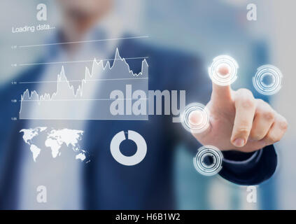 Head-up display interface showing business intelligence dashboard and charts with businessman fingers touching virtual buttons Stock Photo