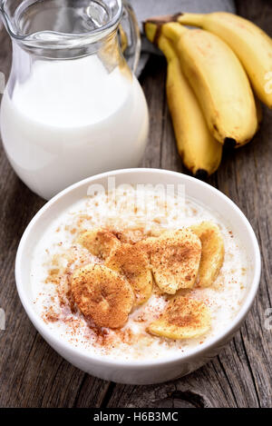 Oatmeal with banana slices and cinnamon, country style Stock Photo