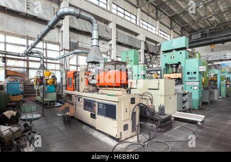 Machine-building plant. Shop with machines for production of plastic parts. Injection molding thermoplastic machine Stock Photo