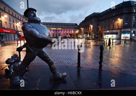 United Kingdom, Scotland, Dundee, the Desperate Dan and his dog Dawg (comic characters) bronze statues, twilight Stock Photo