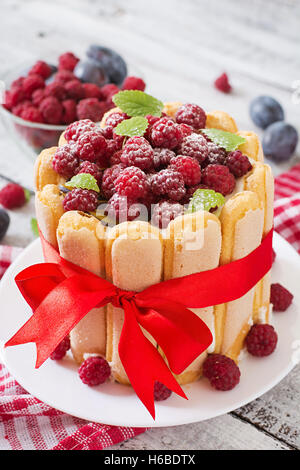 Cake "Charlotte " with raspberries and plums. Stock Photo
