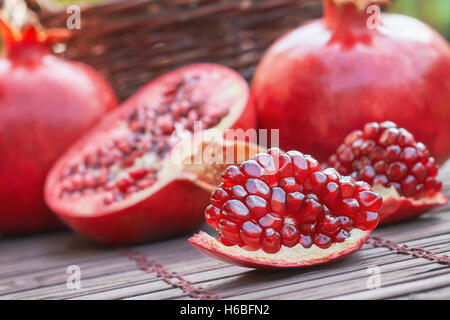Ripe pomegranate fruit on wooden background Stock Photo