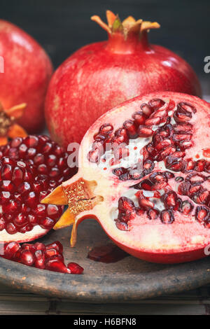 Ripe pomegranate fruit served on rustic plate