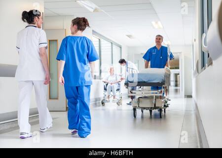 Male nurse pushing stretcher gurney bed in hospital corridor with ...