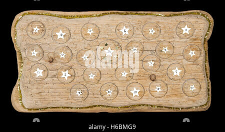 Advent calendar handmade from old timber with circular spaces for small items. Calendar to count the 24 days before Christmas. Stock Photo