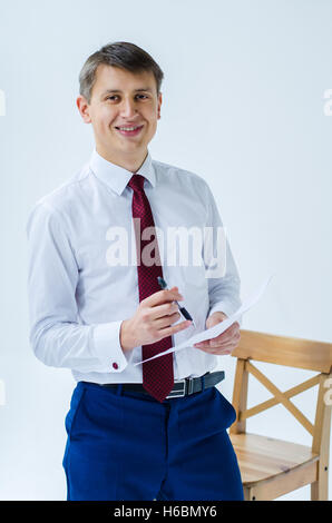 A men in a white shirt boxing smiling standing sitting squatting and shows his straight Stock Photo