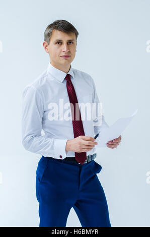 A men in a white shirt boxing smiling standing sitting squatting and shows his straight Stock Photo