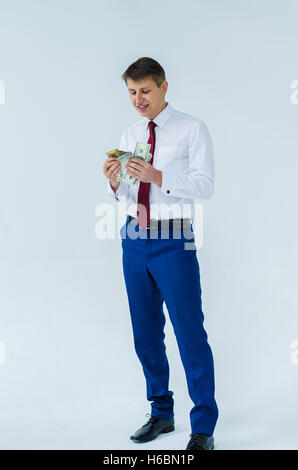 A men in a white shirt boxing smiling standing sitting squatting and shows his straight Stock Photo