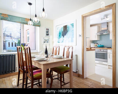 A set table & chairs in a dining room adjacent to the Kitchen in a typical UK home Stock Photo