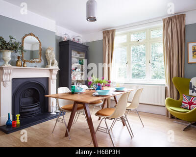 An eclectic, stylish dining area with Victorian period fireplace & features in Gloucestershire, UK Stock Photo