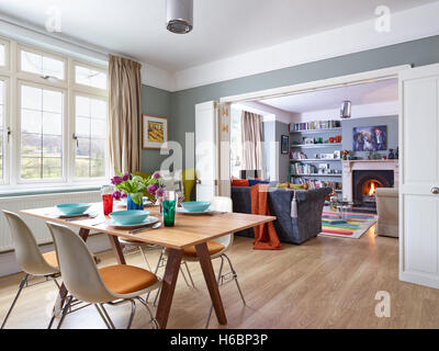 An eclectic, stylish dining area & living room with Victorian period fireplace & features in Gloucestershire, UK Stock Photo