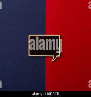Top view of square empty chalkboard wooden speech bubble on red and dark blue background Stock Photo