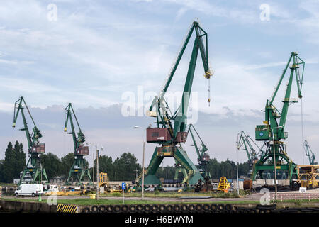 Industry, Top-slewing luffing-jib tower cranes in shipyard operation, views along River Motlawa, Gdansk, Poland Stock Photo