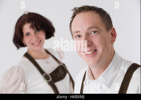 Couple wearing Lederhosen, traditional Bavarian leather shorts Stock Photo