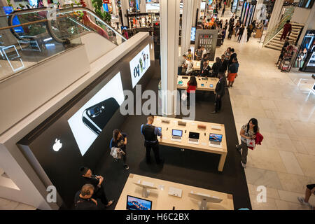 Customers in the newly opened Apple store within Macy's Herald Square in New York on Wednesday, October 19, 2016. The store is staffed by Apple associates and features a range of products. It is the first Apple shop within a department store and it is surrounded by cosmetic kiosks so you can make yourself over for a selfie.   (© Richard B. Levine) Stock Photo