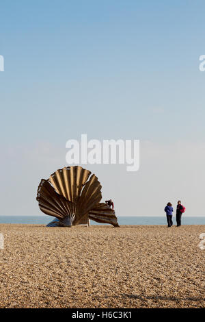 People looking at the Scallop shell sculpture by Maggi Hambling on Aldeburgh beach, Aldeburgh, Suffolk coast, England UK Stock Photo