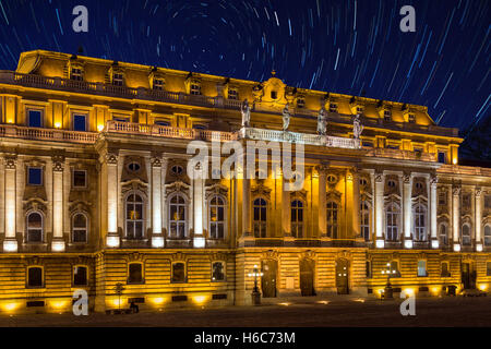 Star Trails in the early Spring sky over Buda Castle in the city of Budapest in Hungary. Stock Photo