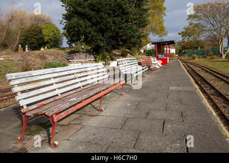 Autumn leaves, empty bench seating on the station tracks of the disused and neglected Lakeside Miniature Railway, Southport, Merseyside, UK Stock Photo