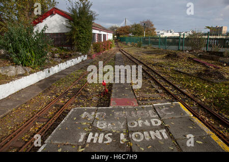 'No Public beyond this point' sign; Autumn leaves on the tracks of the disused and neglected Lakeside Miniature Railway, Southport, Merseyside, UK Stock Photo