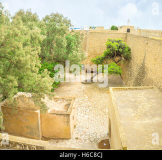 The high citadel walls hide the lush garden in the courtyard, Hammamet, Tunisia. Stock Photo