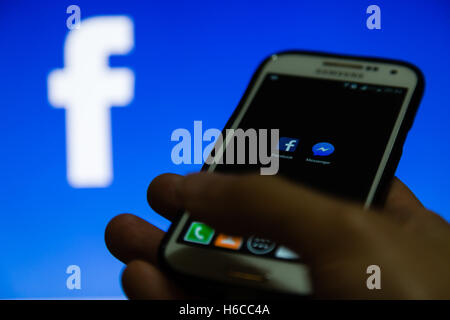 A smartphone display shows Facebook and Messenger application Stock Photo