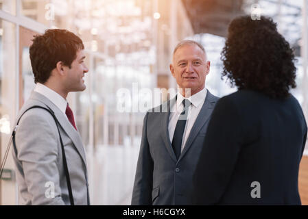Talking business in the office lobby Stock Photo