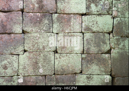 Grunge background of weathered stone blocks with moss discoloration Stock Photo