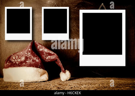 Christmas cards, vintage Santa hat with empty picture frame for put three photos Stock Photo