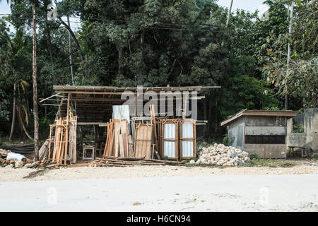 A roadside timber merchant also selling corrugated iron sheets on Zanzibar island Stock Photo