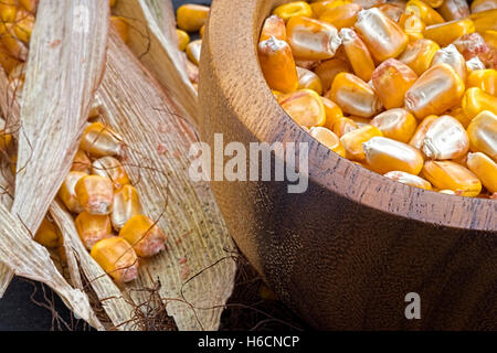 Grains of Yellow Ripe Corn in Wooden Bowl on Rustic Background Stock Photo