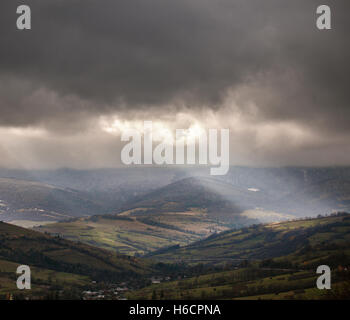 Overcast scene in cloudy mountains. November rain Stock Photo