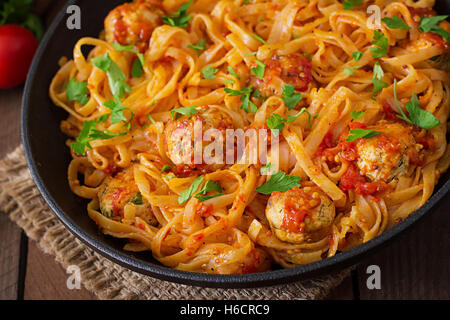 Pasta linguine with meatballs in tomato sauce. Stock Photo