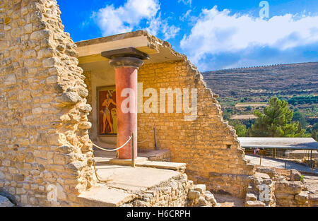 The ruined palace wall with the fresco of Priest-king Relief also famous as Prince of lilies, Knossos Palace Stock Photo