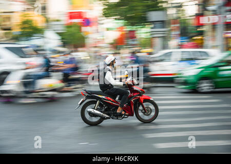 Scooter driver in heavy traffic, motion blur, Ho Chi Minh City, Vietnam Stock Photo