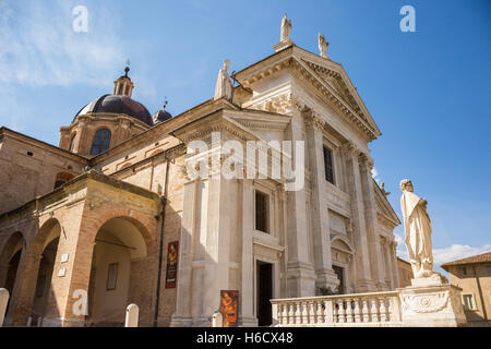 Facade of Santa Maria Assunta Cathedral in Urbino, Marche, Italy. In front of the Dome there id San Crescentino's statue Stock Photo