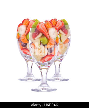 Three colorful, healthy fruit salads in a large glasses, isolated on white Stock Photo