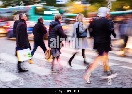 picture in motion blur of people crossing a city street at night Stock Photo