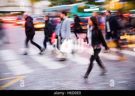 picture in motion blur of people crossing a city street at night Stock Photo